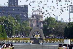 Doves fly over the Peace Memorial Park with a view of the gutted A-bomb dome at a ceremony in Hiroshima, Japan