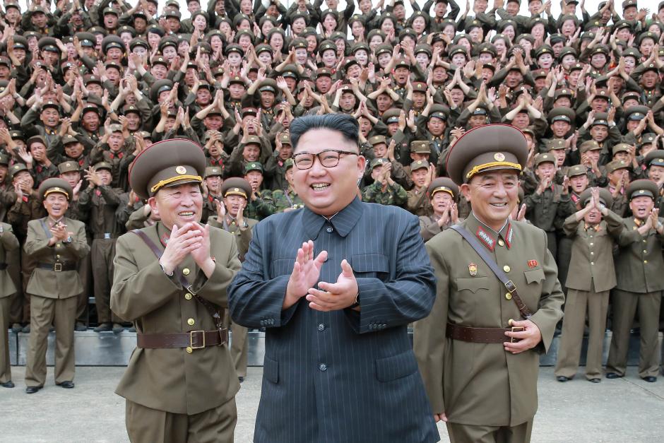 North Korean leader Kim Jong Un claps with military officers at the Command of the Strategic Force of the Korean People's Army (KPA) in an unknown location in North Korea