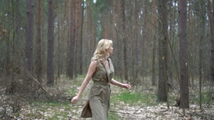 blonde-woman-in-the-forest-running-horror-movie-scene_huggnxwn__F0000